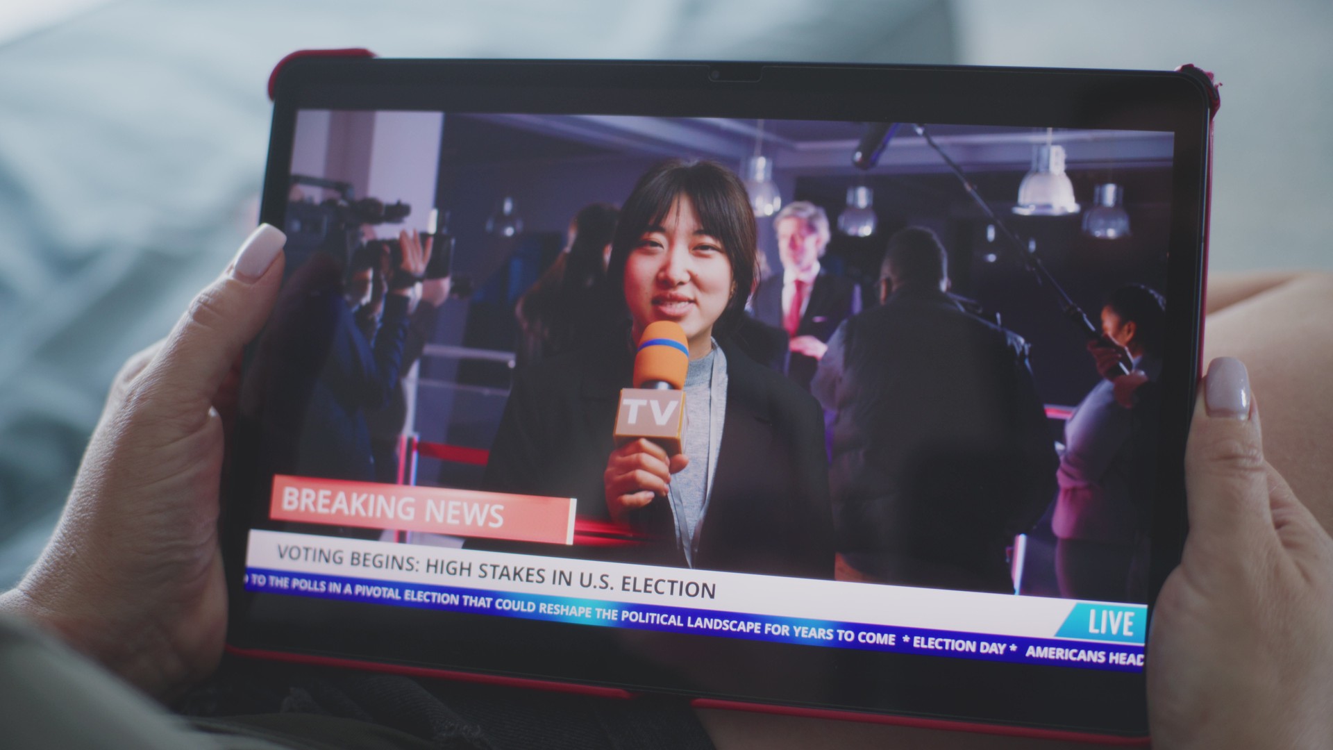 Tablet screen shows playback of news broadcast report about US election